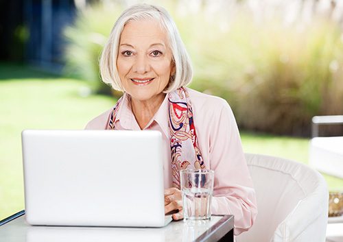 An old woman infront of her laptop